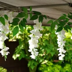 Solar Powered 180cm Artificial Leaf Garland With Wisteria Flowers - Warm White 7 Solar Powered 180cm Artificial Leaf Garland With Wisteria Flowers - Warm White -B&M Garden Shop 379258 180cm solar powered artificial leaf garland with wisteria flowers 20 warm white micro leds